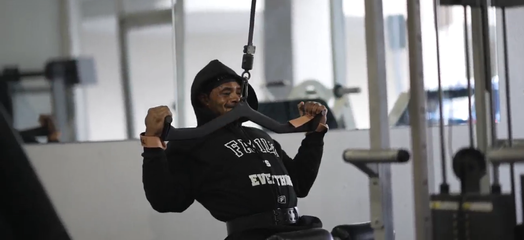 man doing lat pulldowns with lifting straps